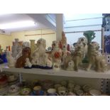 A collection of 19th century Staffordshire spaniel dogs and a pair of 19th century figurines of pugs