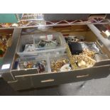 A fruit box full of costume jewellery including gilt metal brooches and earrings, a silver ARP