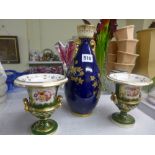 A pair of small early 19th century English porcelain urn-shaped vases, with panels of flowers on a