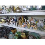 Two shelves of animal figurines from the 1920's onwards including cats, dogs, birds, penguins,