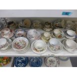 A shelf of English porcelain tea ware, early to mid 19th century, including many hand-coloured