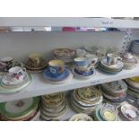 Three shelves of assorted cups and saucers dating from 19th century onwards [s50] ONLINE BIDDING