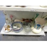 A shelf of mixed items including two modern glass decanters and stoppers one with gilt decoration,