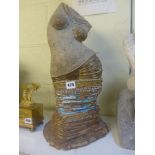 A stoneware sculpture by Melanie Keevil, of a female torso in an exotic dance, signed, dated 1997,