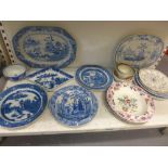 A shelf of early 19th century English pottery, mainly blue-printed, including a Leeds Pottery marked