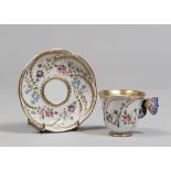 PORCELAIN CUP AND SAUCER, PROBABLY PARIS EARLY 20TH CENTURY of white glaze, polychromy and gold,