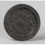 CAST-IRON BAS-RILIEF DISH, LATE 19TH CENTURY chiseled in scenes biblical and to lilies and coats