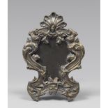 A SMALL SILVERED AND GILDED METAL MIRROR, 19TH CENTURY entirely hurled to roccailles, leaves and