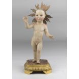 FIGURE OF JESUS' CHILD, NAPLES 19TH CENTURY In lacquered wood with eyes in glass. Aureole and