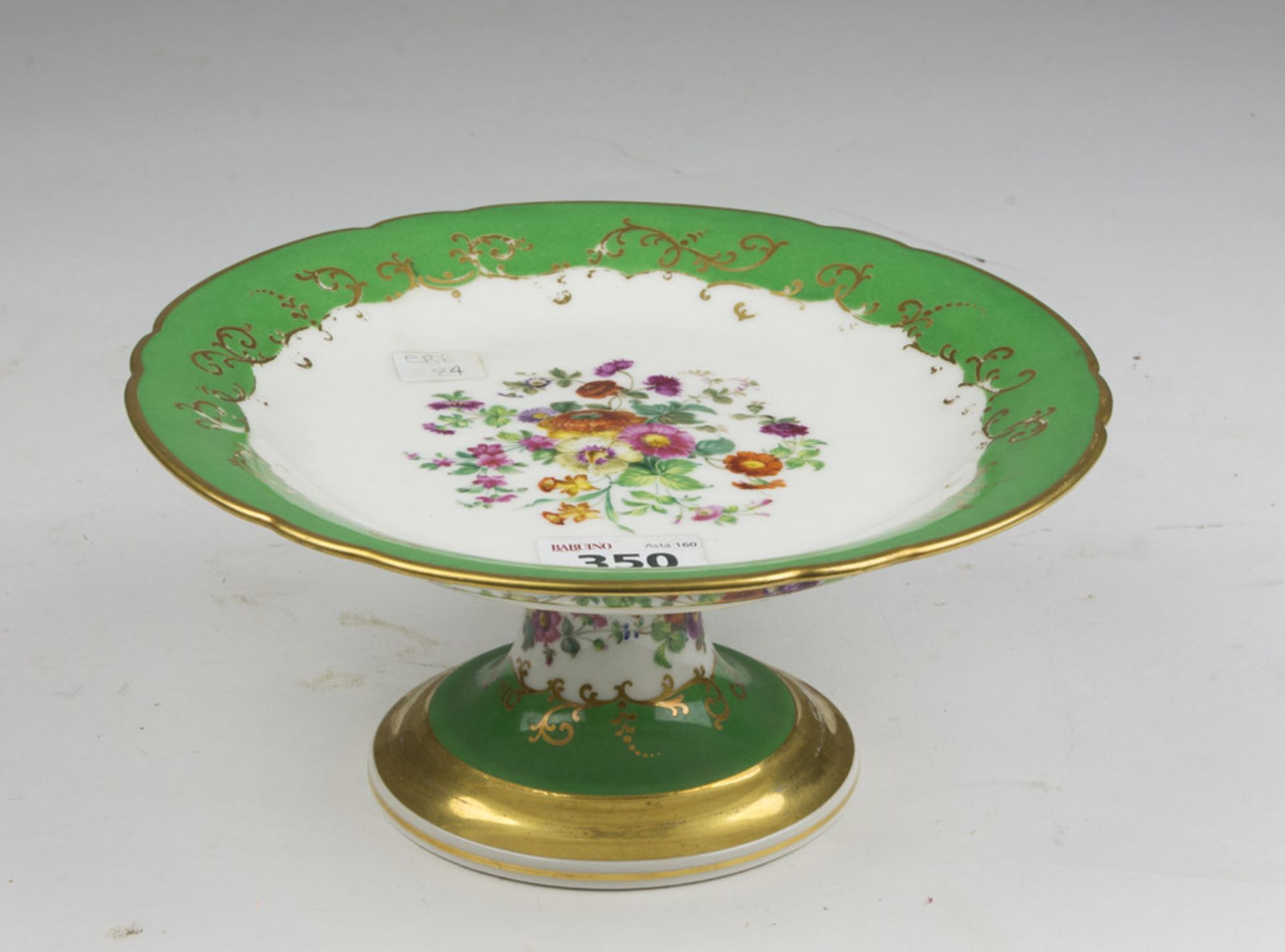 PORCELAIN CAKESTAND, 19TH CENTURY of white and green enamel decorated with colored flowers. Measures