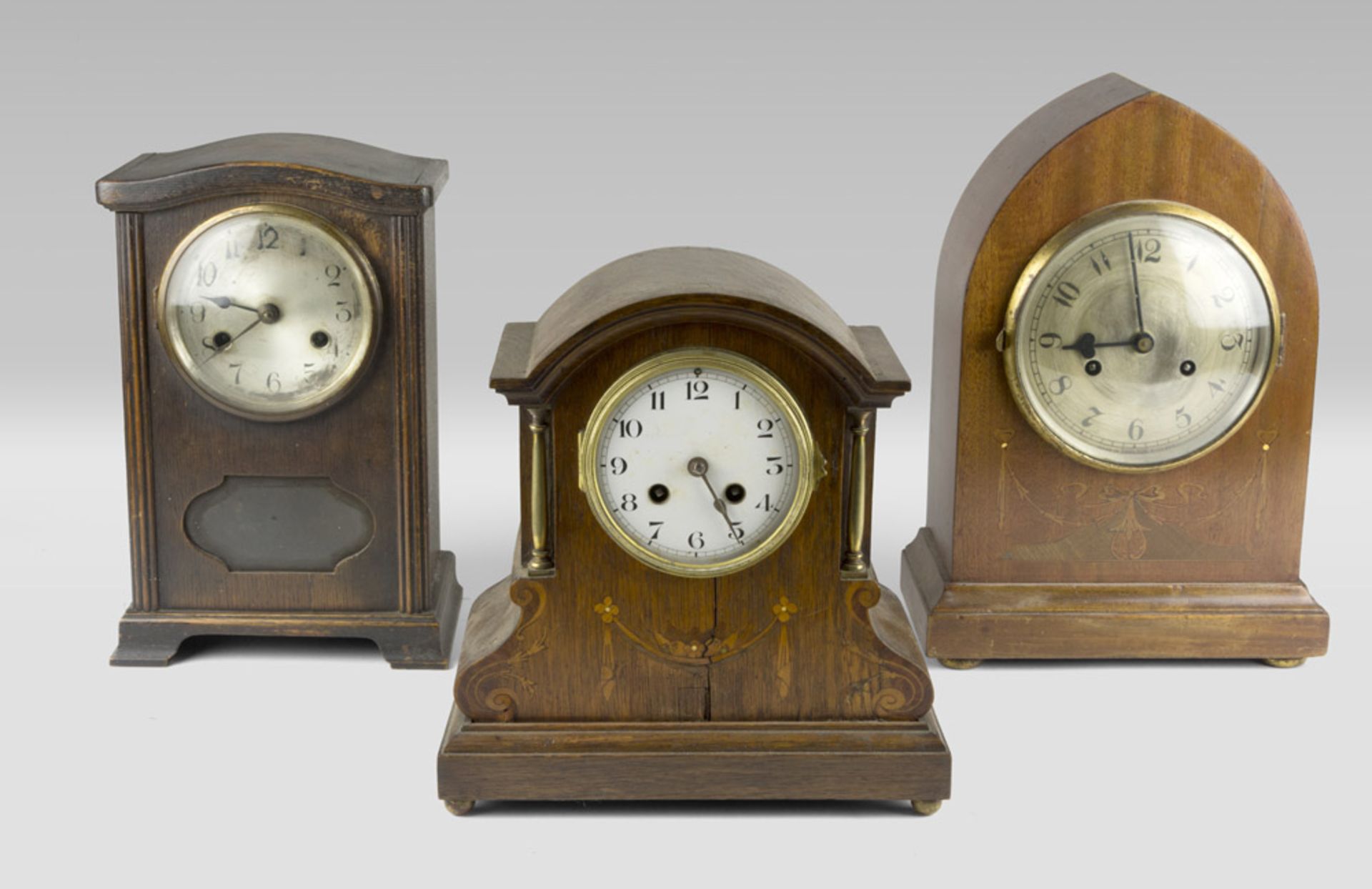 THREE TABLE CLOCKS, ENGLAND LATE 19TH CENTURY cases in mahogany and oak. One with inlays in fruit