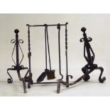 FIREPLACE SET IN WROUGHT IRON, 20TH CENTURY consisting in a pair of alari and three utensils with
