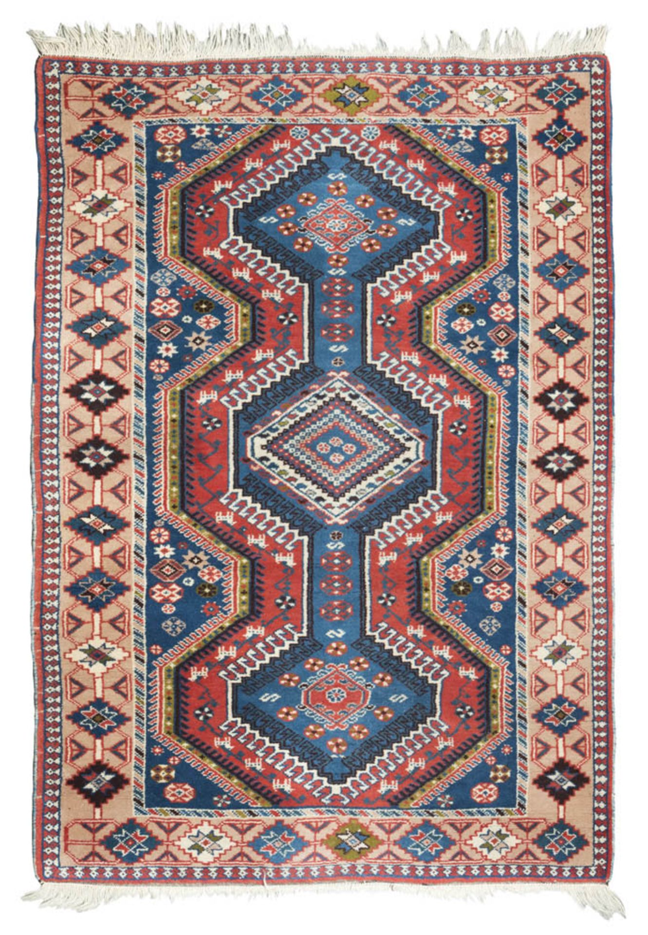 A RARE SHIELD KAZAK RUG, EARLY 20TH CENTURY with great medallion in blue and secondary motives to