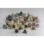 QUANTITY OF EGGS IN MARBLES AND HARD STONES 20TH CENTURY some with supports of metal and wood.