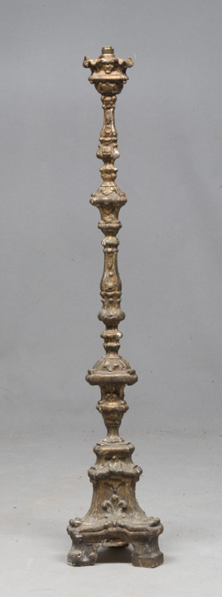 GILTWOOD FLOOR CANDLESTICK, 18TH CENTURY carved to leaves and pods. Triangular knots and basement.