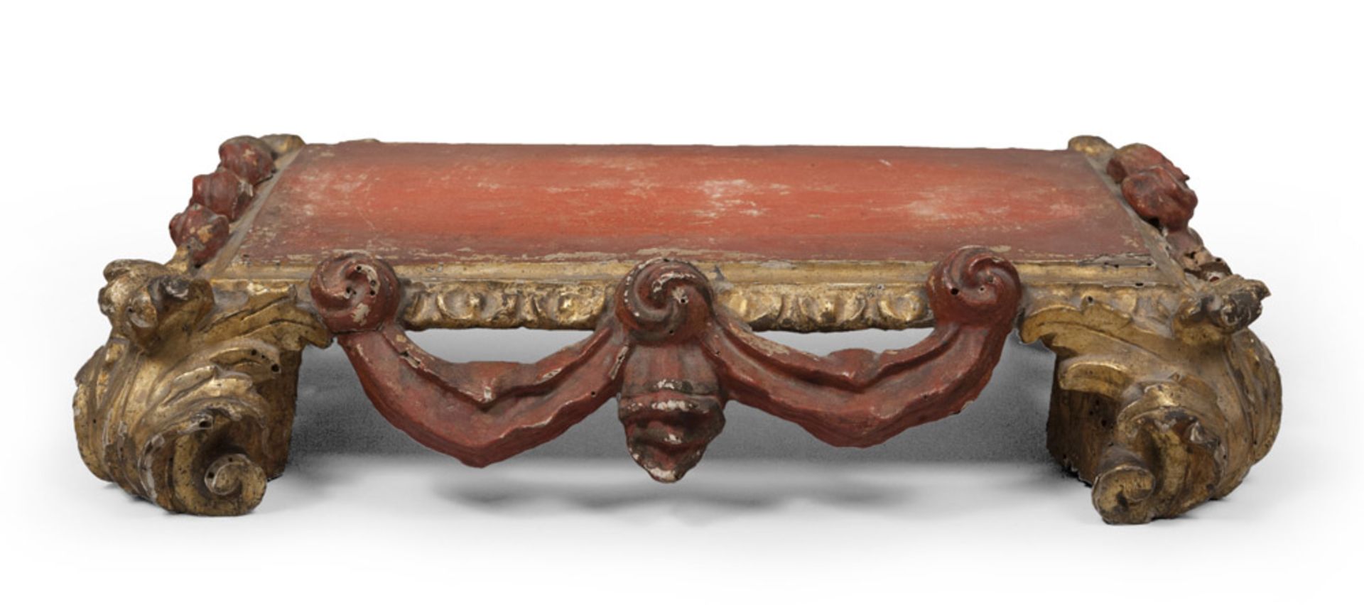 GILTWOOD BASE, NAPLES BAROQUE PERIOD with red lacquered top and draperies. Feet in twisted leaves.