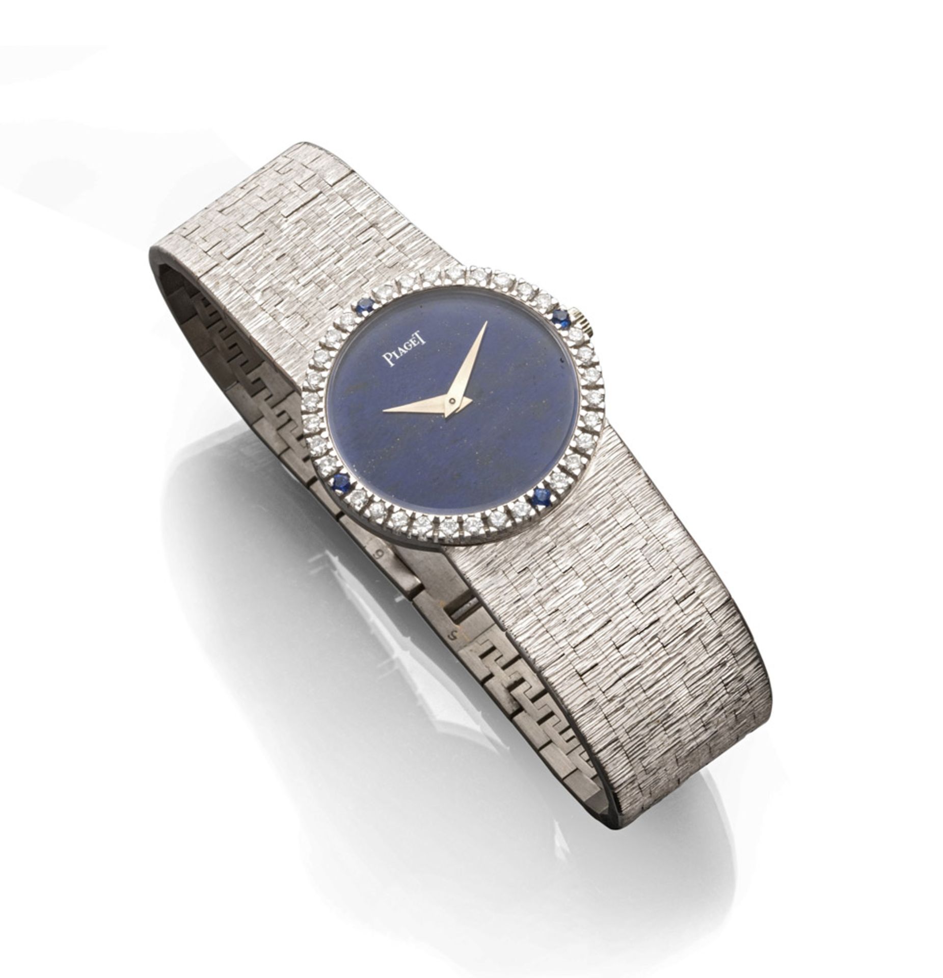 WOMAN'S WRIST WATCH, BRAND PIAGET entirely in white gold 18 kts., with blue glazed dial surrounded