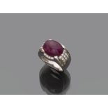 RING in white gold 18 kts., dome shape with central ruby cabochon cut and diamonds of contour