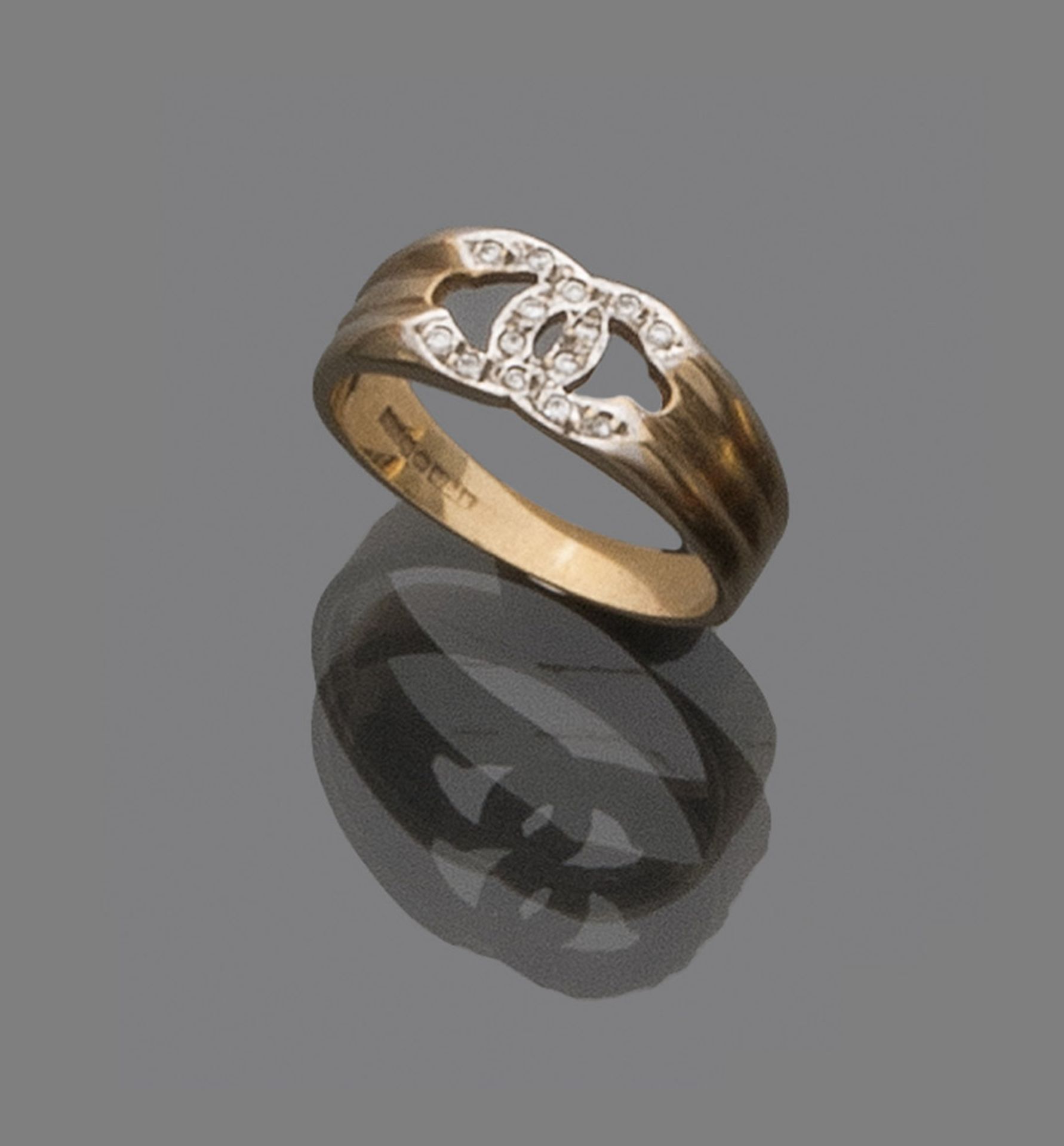 RING in yellow gold 9 kts., model Chanel, decorated with small diamonds. Total weight gr. 3,40.