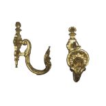 A PAIR OF BRONZE CURTAIN-HOLDERS, LATE 18TH CENTURY chiseled roccailles, with a twisted arm.