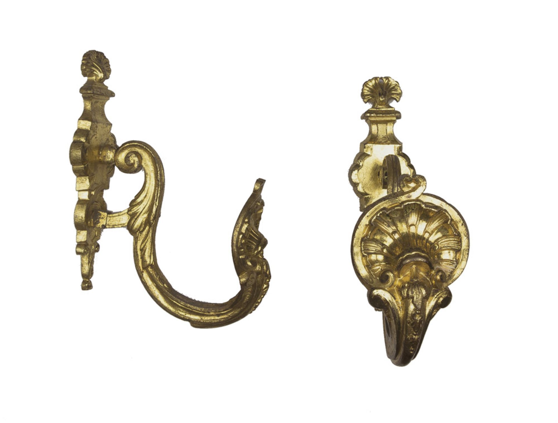 A PAIR OF BRONZE CURTAIN-HOLDERS, LATE 18TH CENTURY chiseled roccailles, with a twisted arm.