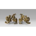 A BEAUTIFUL PAIR OF FIREDOGS IN ORMOLU, 18TH CENTURY with upright chiseled to twisted leaves with