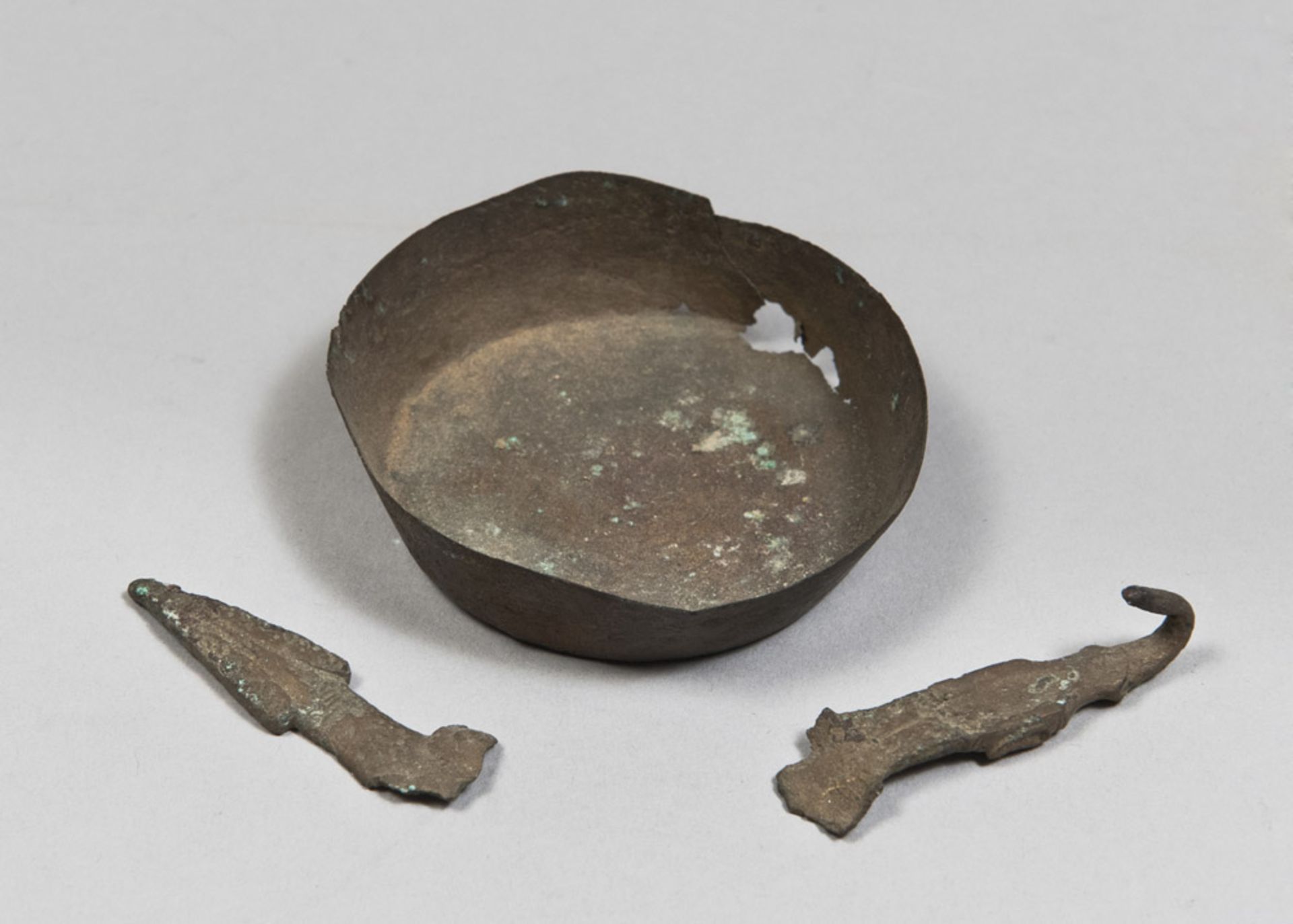 ONE BOWL AND TWO OBJECTS IN BRONZE, 3rd-1st CENTURY A.C. consisting of a small bronze bowl, a buckle