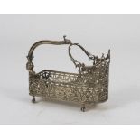 SILVER-PLATED BOTTLEHOLDER, 20TH CENTURY entirely pierced to vegetable motifs and palmette. Handle