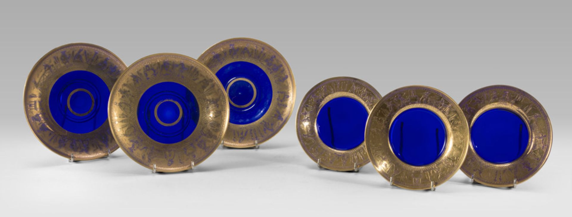 ELEVEN SAUCERS IN COBALT GLASS, VENICE EARLY 20TH CENTURY of three dimensions, with edge in gold