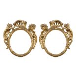 A PAIR OF SMALL GILTWOOD FRAMES, 18TH CENTURY to racemes with climbing leaves of acanthus and hat to