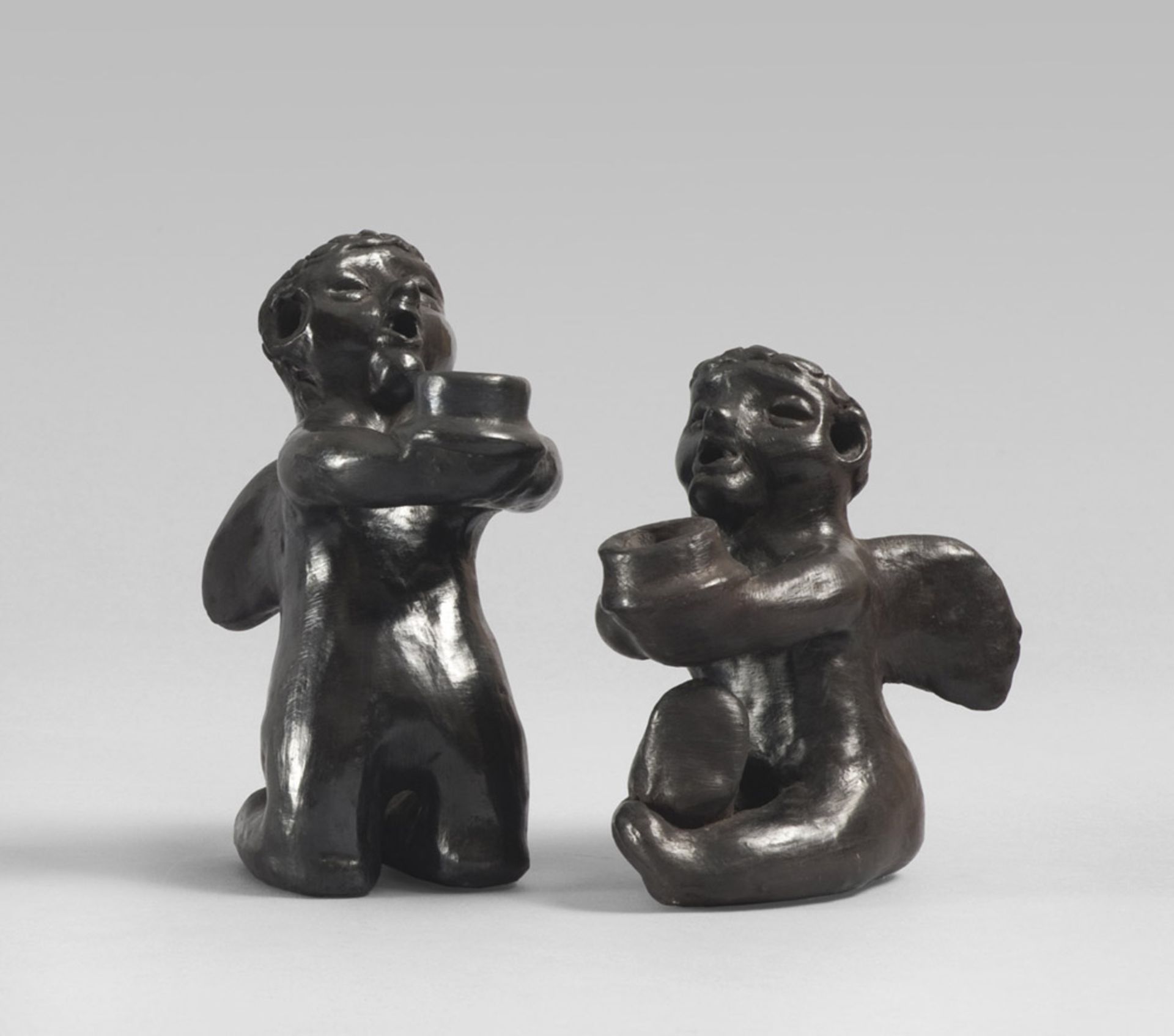 A PAIR OF POTTERY CANDLESTICKS, SOUTH AMERICA, 20TH CENTURY