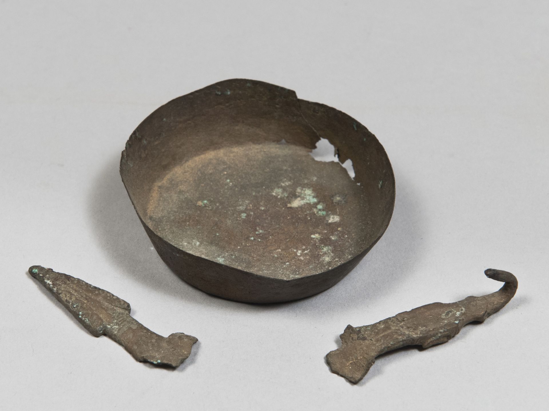 ONE BOWL AND TWO OBJECTS IN BRONZE, 3rd-1st CENTURY A.C. consisting of a small bronze bowl, a buckle