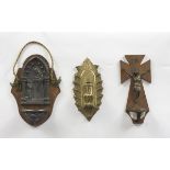 THREE HOLY WATER STOUPS IN METAL AND PEWTER, EARLY 20TH CENTURY surmounted by devotional figures.