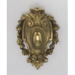 SMALL FRIEZE IN ORMOLU, END 19TH CENTURY shaped as coat of arms with garlands. Measures cm. 19 x
