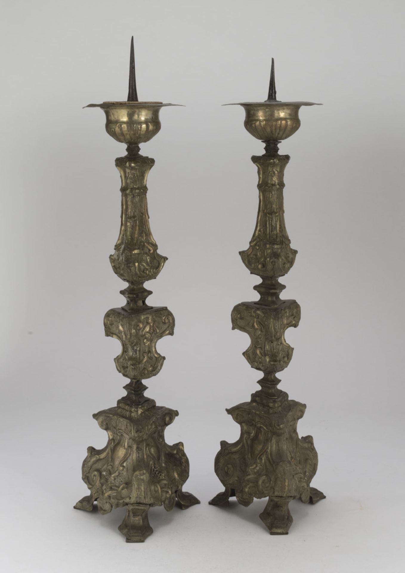 A PAIR OF SILVER-PLATED CANDLESTICKS, ROME SECOLO shaft embossed with spirals and leaves. Triangular