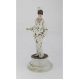 BISCUIT FIGURE OF PULCINELLA, 20TH CENTURY with porcelain base. Signed 'Roberto B.' h. cm. 33.