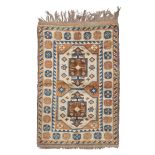 KARS CARPET, MID TWENTIETH CENTURY medallion with double niche in the central field at the bottom of