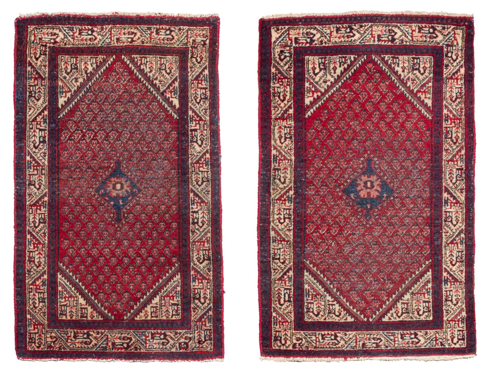 A PAIR OF HAMADAN BED RUGS, EARLY 20TH CENTURY with boteh design n the center field on red ground.