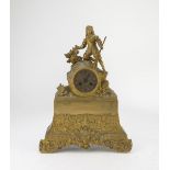 TABLE CLOCK IN ORMOLU, 19TH CENTURY with hunter's figure above the dial. Rectangular base chiseled