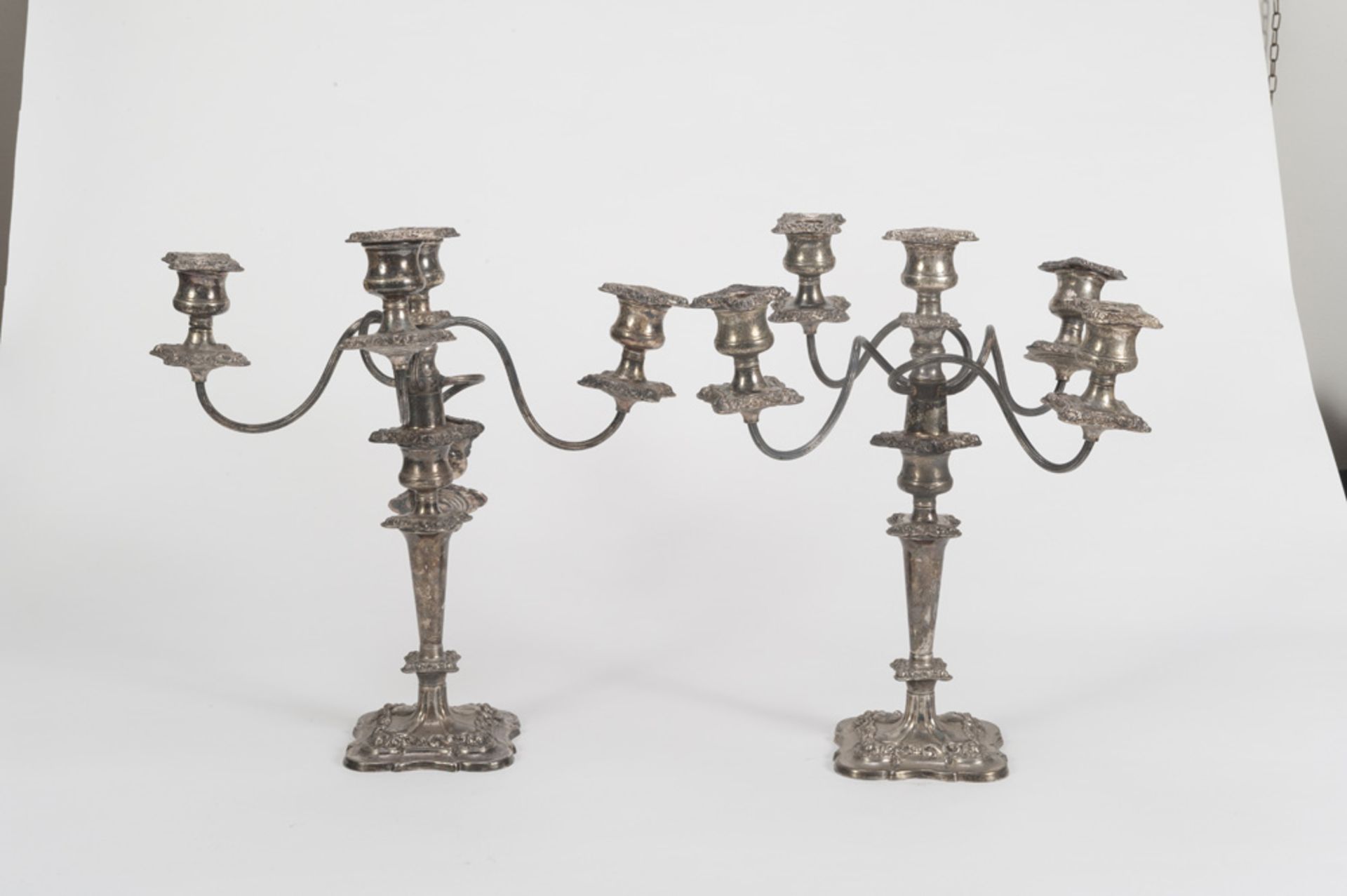 A PAIR OF SILVER-PLATED CANDELABRA ENGLAND LATE 19TH CENTURY five arms, with mouthpieces chiseled to