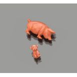 TWO PENDANTS in pink coral, shaped to piglet and dog. Measures piglet cm. 4,5 x 3. DUE CIONDOLI in