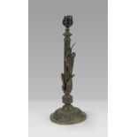 CANDLESTICK IN BURNISHED METAL, 20TH CENTURY fluted shaft with climbing leaves. Measures cm. 36 x