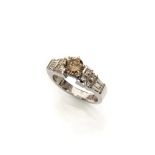 RING in white gold 18 kts., with central brown diamond and sid tepper-cut and prince-cut side