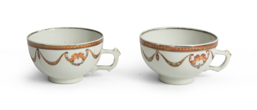 A PAIR OF PORCELAIN CUPS, 19TH CENTURY decorated with garlands and flowers. Not marked. Measures cm.