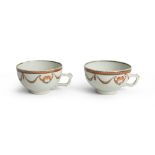 A PAIR OF PORCELAIN CUPS, 19TH CENTURY decorated with garlands and flowers. Not marked. Measures cm.