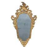 SMALL GILTWOOD MIRROR, VENETIAN, END 18TH CENTURY with cartouche frame, garnished by carvings to