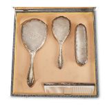 SILVER TOILET SET , PUNCH FLORENCE 1934/1944 consisting of two brushes, a comb and a hand mirror.