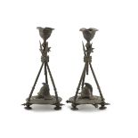 A PAIR OF SMALL CANDLESTICKS IN BURNISHED METAL, 19TH CENTURY tripod of halberds. Measures cm. 22