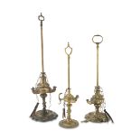 THREE FLORENTINE OIL LAMPS IN BRASS, LATE 19TH CENTURY three and one flame, with round bases.