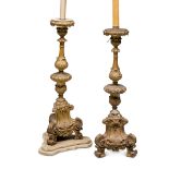 A PAIR OF GILTWOOD CANDLESTICKS, 18TH CENTURY sculpted with triangular base and curled feet.